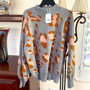 Lovely Stellah sweater. Silver with rust/peach design.  100 %poly.